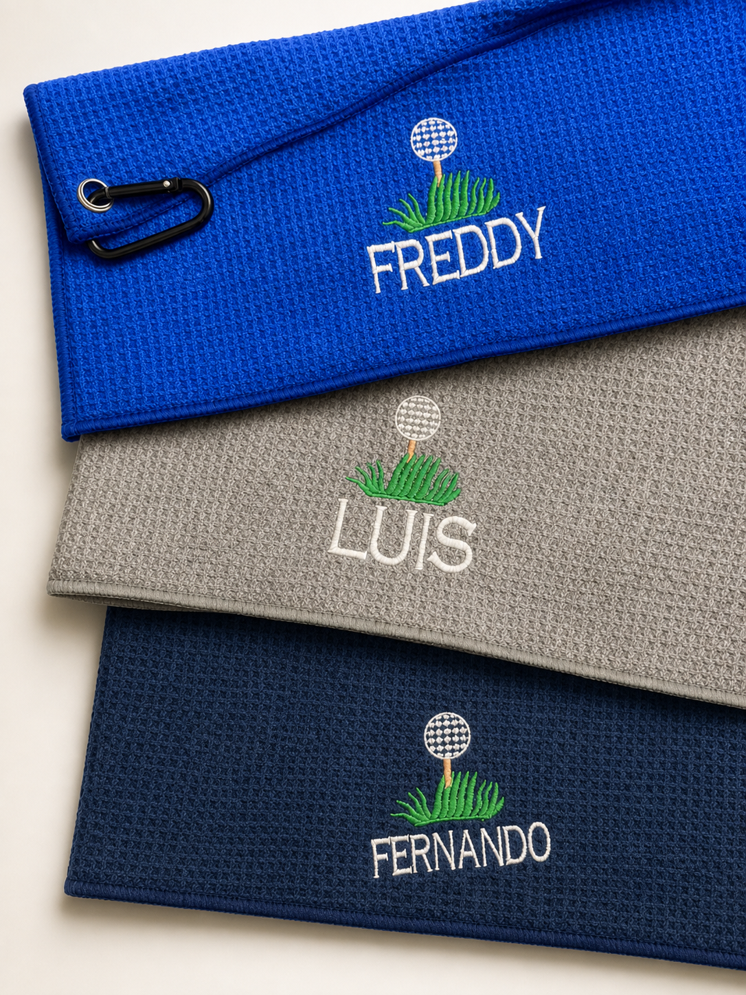 Three personalized golf towels embroidered by Figstitch