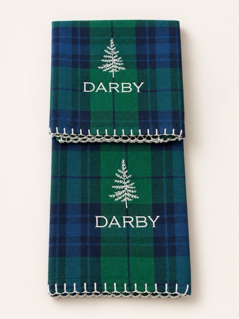 Green and navy plaid linens embroidered with evergreen trees