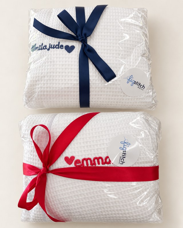 Personalized waffle robes wrapped with ribbons and Figstitch gift tags