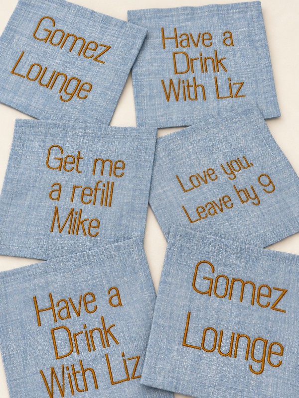 Six blue cocktail napkins with gold Gomez Lounge, Have a Drink With Liz, Get me a refill Mike, and Love you, Leave by 9 embroidery.